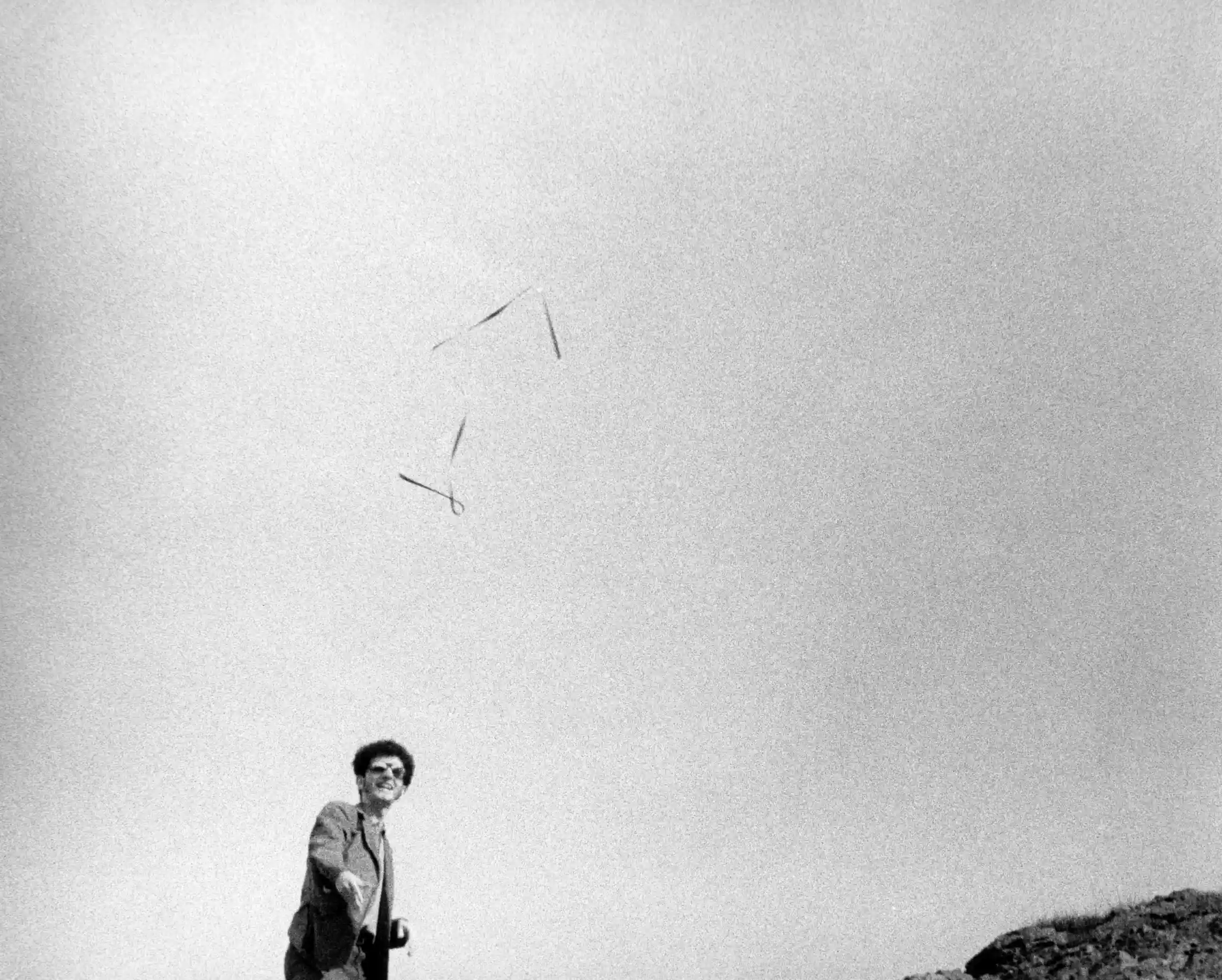 Tom Marioni's One Second Sculpture, 1969 — a metal tape measure spring suspended mid-air above the artist.