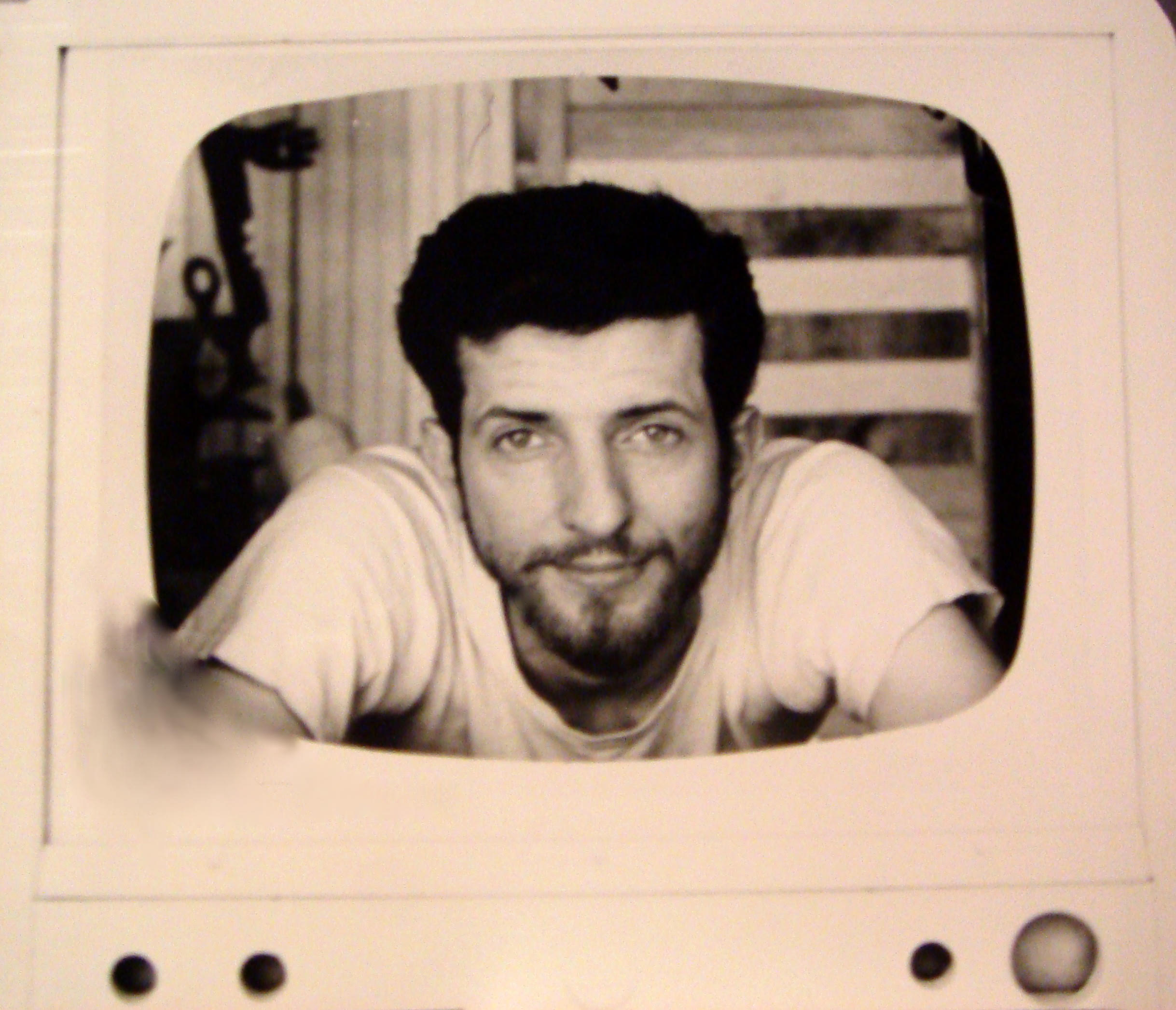 Tom Marioni in 1965, photographed inside the cutout of a television set.